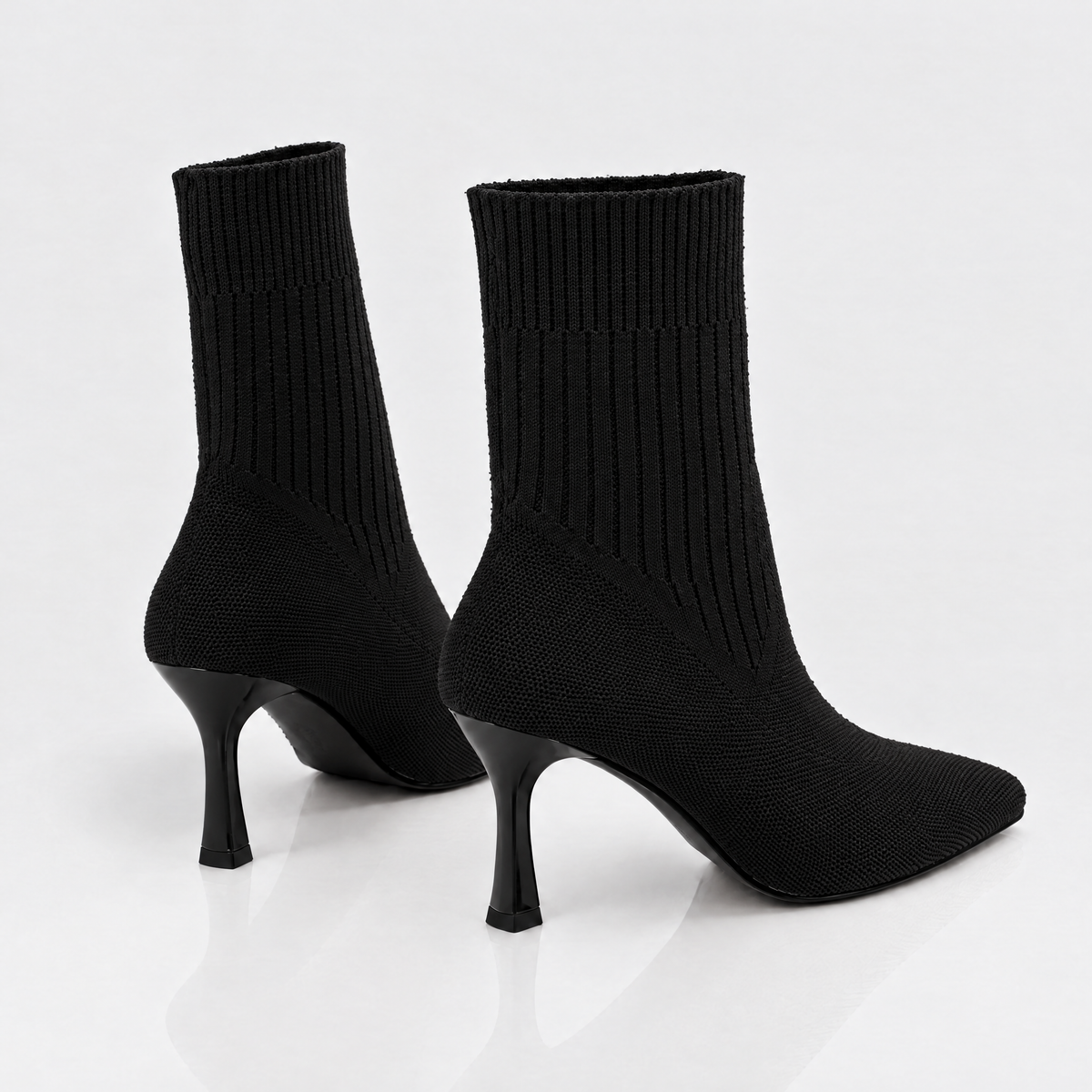 Pair of black sock boots, back view